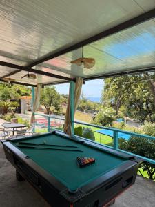 a pool table on a patio with a view at villa Cycas in Maratea