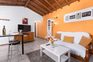 a living room with a white couch and a table at Home2Book Las Tinajas A, Peaceful Retreat in Triquivijate