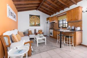 a kitchen and living room with a couch and a table at Home2Book Las Tinajas A, Peaceful Retreat in Triquivijate