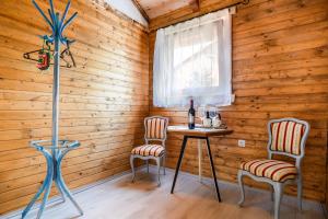 a room with a table and two chairs and a window at Etno wooden room in Rakovica