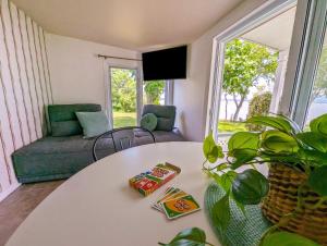 a living room with a table and a couch at Chalet #2 Waterfront with Spa, Fireplace Wifi & AC in Cap-Saint-Ignace +32 photos
