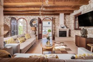 a living room with a couch and a table at Nephele 3 bedroom villa with private pool in Akrotiri