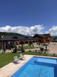 a resort with a swimming pool and a house at Bucovina Exclusiv in Vama
