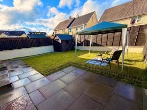 a gazebo with a table and a chair in a backyard at Brady Accommodation in Monaghan