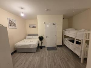 a room with two bunk beds and a staircase at Shamrock Premium Apartment in Cork