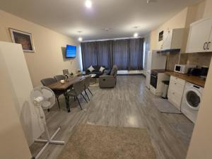 a kitchen and a living room with a table and a dining room at Shamrock Premium Apartment in Cork