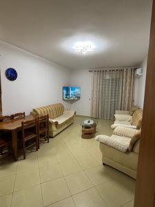 a living room with two couches and a table at Emily House in Fier