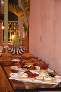 a table with different types of pastries on plates at Wave chaser surfhouse morocco in Agadir