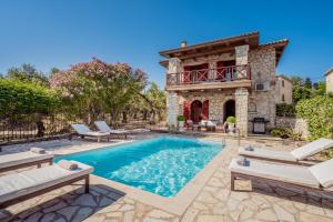 a house with a swimming pool and a building at Nephele 3 bedroom villa with private pool in Akrotiri