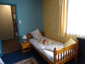 a dog laying on a bed in a bedroom at Roses de Picardie in Chauny