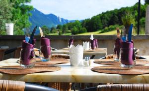 a set of tables with purple boots on top of them at Auberge le Collet in Saint-Agnan-en-Vercors