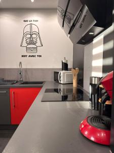 a kitchen with a counter top with a microwave at Le 7ème Art in Hombourg-Haut +14 photos