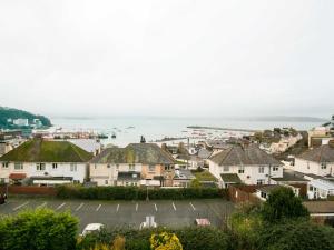 a view of a town with houses and the ocean at Ranscombe House in Brixham