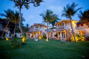 a large house with palm trees in the yard at FlowHouse Jeri - Hotel & Coworking in Jericoacoara