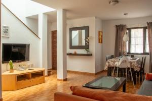 a living room with a couch and a table at Casa Be in Caleta De Fuste