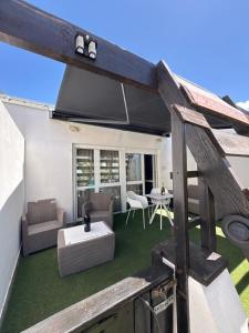 an outdoor patio with a table and chairs and a table at Port nature 2 Villas studio in Cap d'Agde