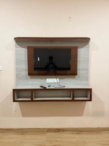 a flat screen tv on a wall in a room at Shada Shiv Heritage, Omkareshwar in Godarpura