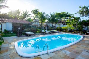 a swimming pool in the middle of a yard at FlowHouse Jeri - Hotel & Coworking in Jericoacoara