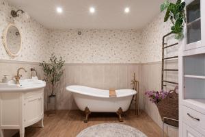 a white bathroom with a tub and a sink at JW Apartments in Krościenko +94 photos
