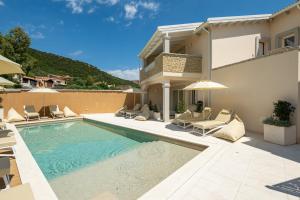 a villa with a swimming pool and a house at Borgo Myricae in Chia