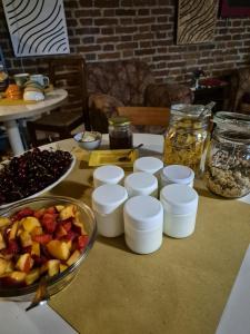 a table with a bowl of fruit and a bowl of nuts at Agribirrificio Corte Petacchi in Volta Mantovana