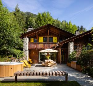 a house with a deck with a bench in front of it at Three Bedroom Chalet Lemon Pit Chamonix in Chamonix