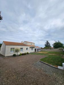 a house with a gravel driveway in front of it at Les Renaudelles in Angles