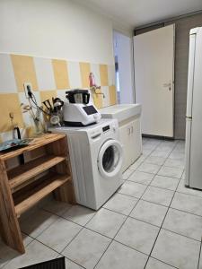a kitchen with a washing machine on a counter at Les Renaudelles in Angles