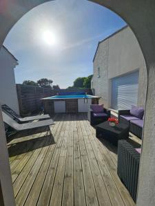 an outdoor patio with a pool and a deck at Les Renaudelles in Angles
