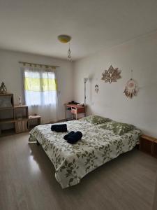 a bedroom with a bed with two bags on it at Les Renaudelles in Angles +5 photos