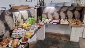 a buffet with many different types of food on display at Butterfly Home Danube in Budapest