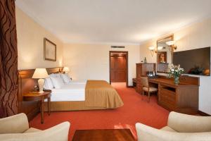 a hotel room with a bed and a desk at Crystal Palace Boutique Hotel in Sofia +86 photos