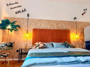 a bedroom with a large bed with a large headboard at CASA Salzburg in Salzburg