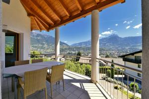 a view from the balcony of a house with a table and chairs at Chalet Anna in Marlengo