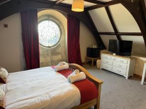 a bedroom with a large bed and a window at St Nicholas Hotel Shrewsbury in Shrewsbury