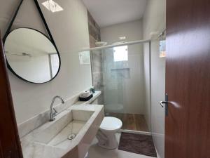 a bathroom with a sink and a toilet and a mirror at Casa Villa Serrano in Lençóis +43 photos