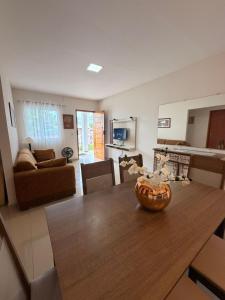 a kitchen and living room with a wooden dining table at Casa Villa Serrano in Lençóis