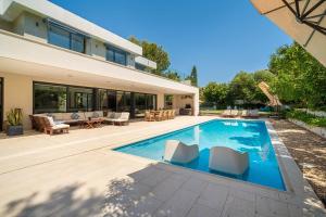 a swimming pool in the backyard of a house at Villa SP1 Suites Santa Ponsa by Sealand Villas in Santa Ponsa