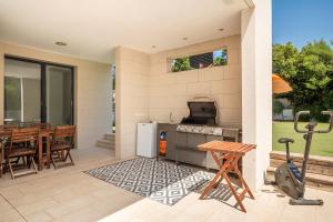 a patio with a stove and a table and chairs at Villa SP1 Suites Santa Ponsa by Sealand Villas in Santa Ponsa