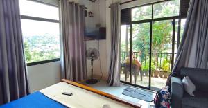 a bedroom with a bed and a large window with a view at S V homestay in Kandy