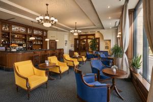 a restaurant with chairs and tables and a bar at Crystal Palace Boutique Hotel in Sofia