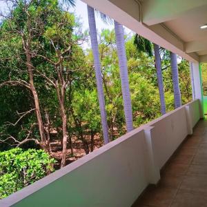 a balcony of a building with trees in the background at Hotel Marigold Vasad in Vāsad