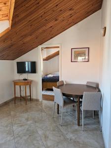 a room with a table and chairs and a bed at Apartmani Banić Apartman 4 in Postira