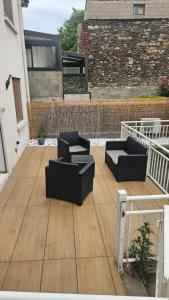 a patio with two couches sitting on a deck at La consulte - exceptional apartment in Saint-Étienne