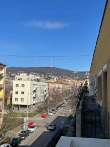 a view of a city street with a lighthouse in the distance at Sweet Escape Pécs in Pécs