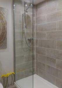 a shower with a glass door in a bathroom at City Centre Haven Apartments in Edinburgh