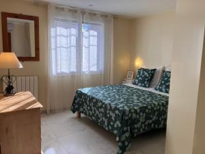 a bedroom with a bed and a window at La Catalane in Perpignan