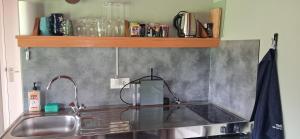 a kitchen with a sink and a counter top at Tinyhouse De Woord in Corle