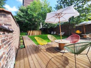 a patio with a table and chairs and an umbrella at L'atelier in Verviers