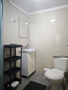 a bathroom with a toilet and a sink at Elina House 2 in Nikiti +17 photos